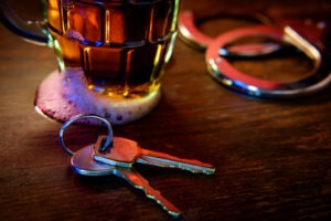 A set of car keys by a mug of beer before a DUI accident. After a wreck, you can get help from a Jacksonville DUI accident victim lawyer.